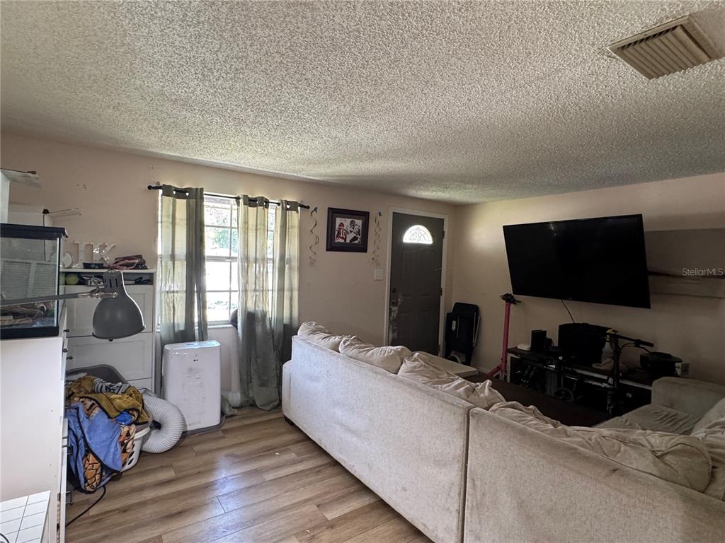 1004 Melrose Street Seffner, FL 33584 - Photo 5 of 40 a bedroom with a bed and a flat tv screen on the dresser