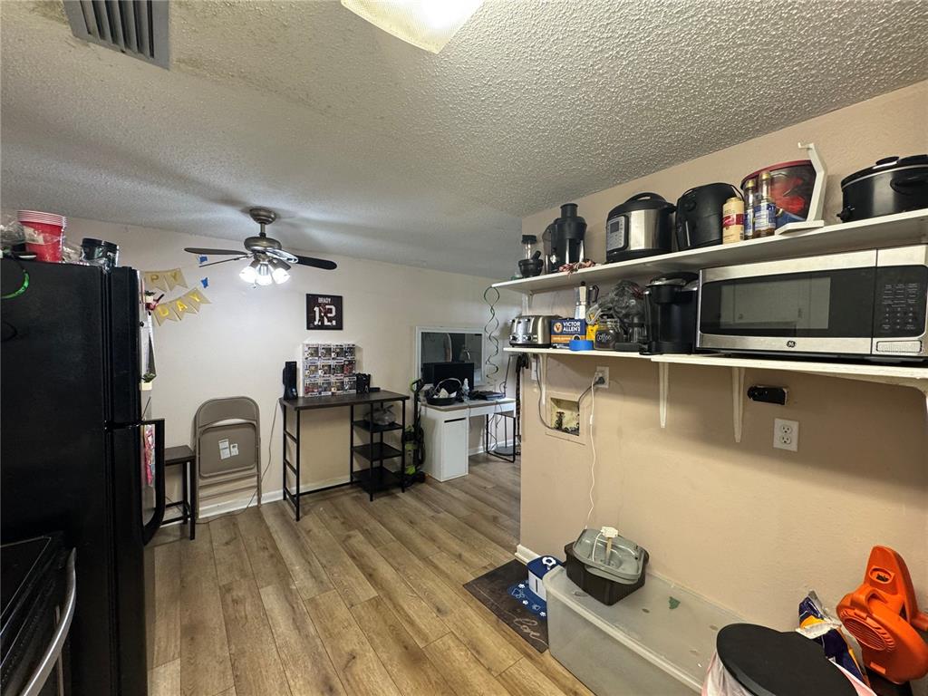 1004 Melrose Street Seffner, FL 33584 - Photo 9 of 40 a kitchen with a refrigerator and a stove top oven