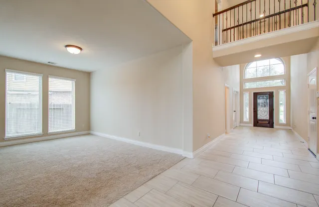 a view of an empty room with a fireplace and a window