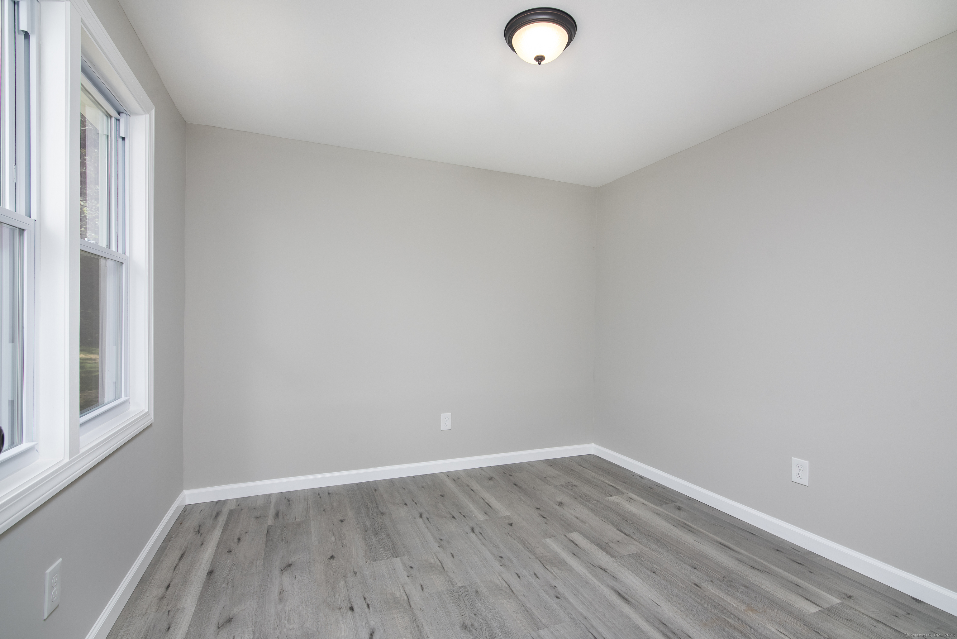 260 Hayden Hill Road Torrington, CT 06790 - Photo 13 of 18 a view of a room with wooden floor and windows