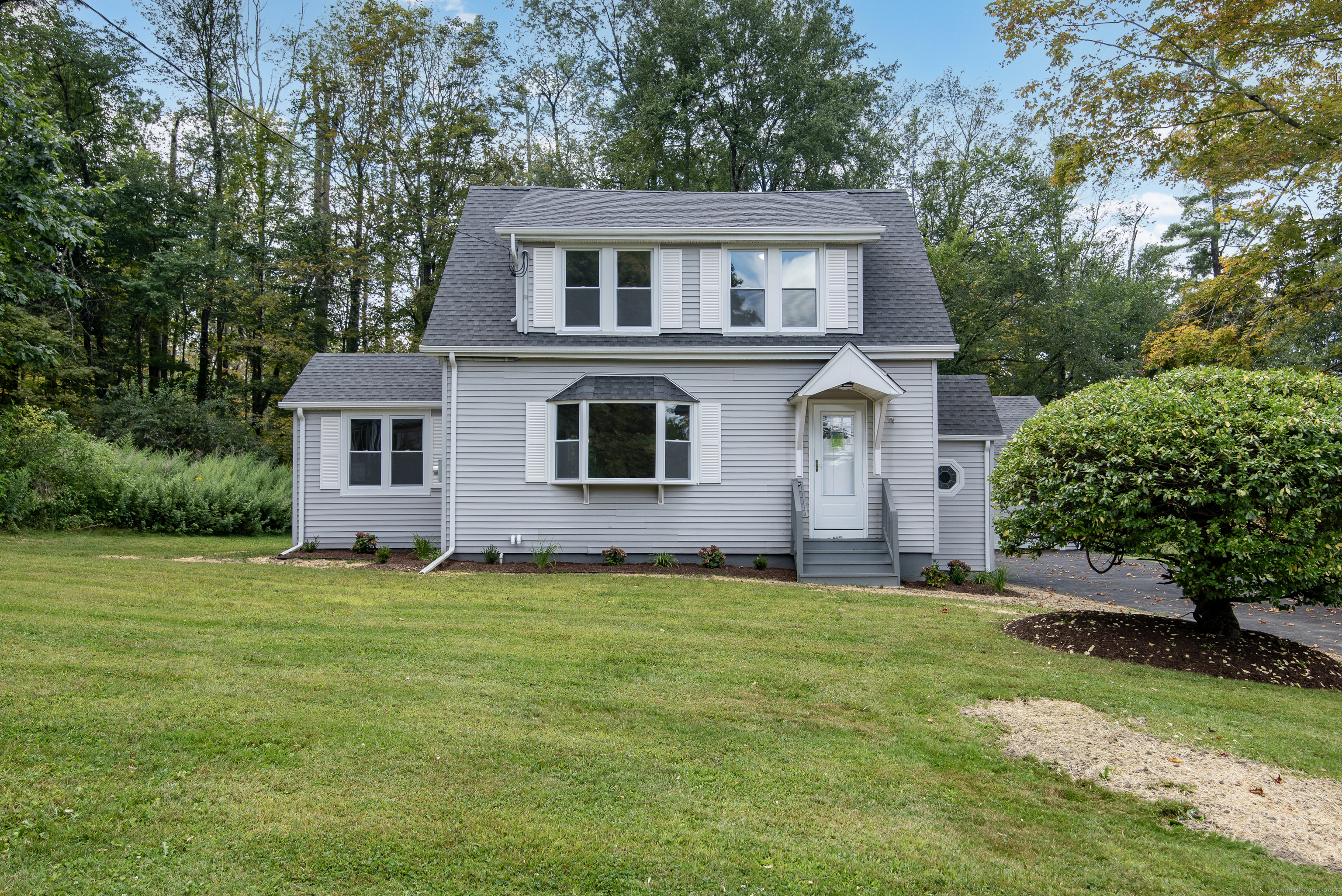 260 Hayden Hill Road Torrington, CT 06790 - Photo 2 of 18 a house that is sitting in the grass with large trees