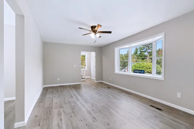 wooden floor in an empty room with a window