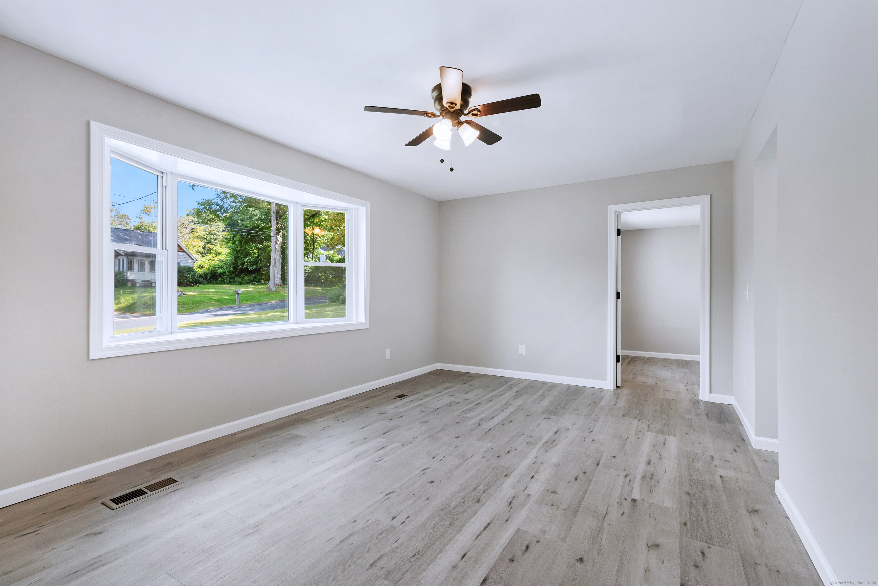 260 Hayden Hill Road Torrington, CT 06790 - Photo 7 of 18 a view of an empty room with wooden floor and a window