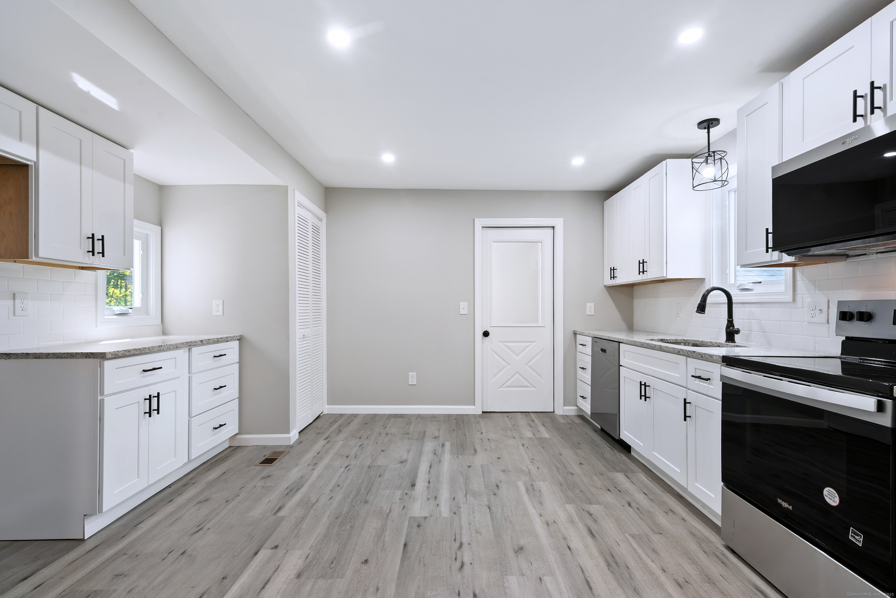 260 Hayden Hill Road Torrington, CT 06790 - Photo 8 of 18 a large kitchen with cabinets wooden floor and stainless steel appliances
