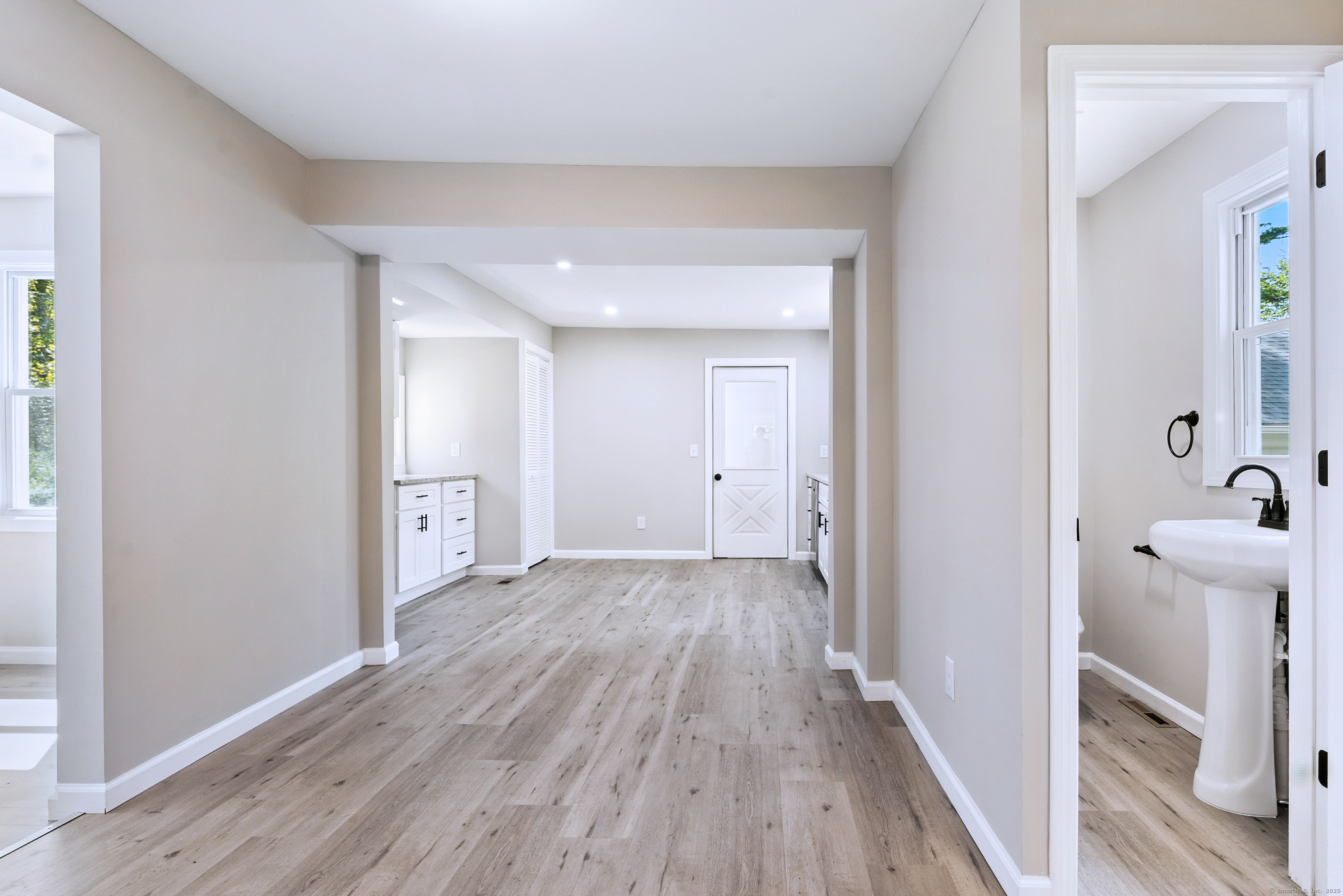 260 Hayden Hill Road Torrington, CT 06790 - Photo 10 of 18 a view of a hallway with wooden floor and a bathroom