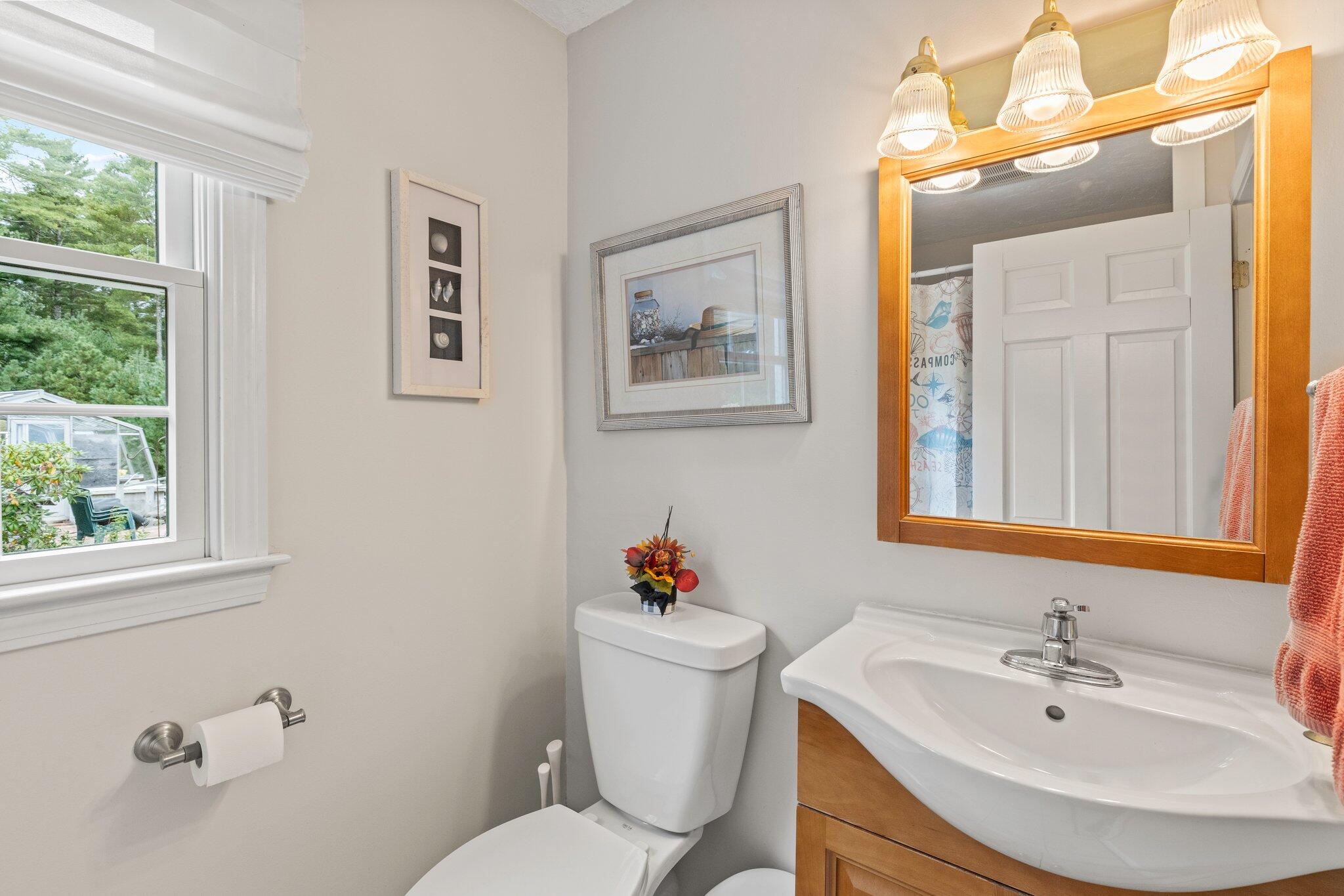 3 Fathom Lane Wareham, MA 02571 - Photo 16 of 57 a bathroom with a sink mirror and a toilet
