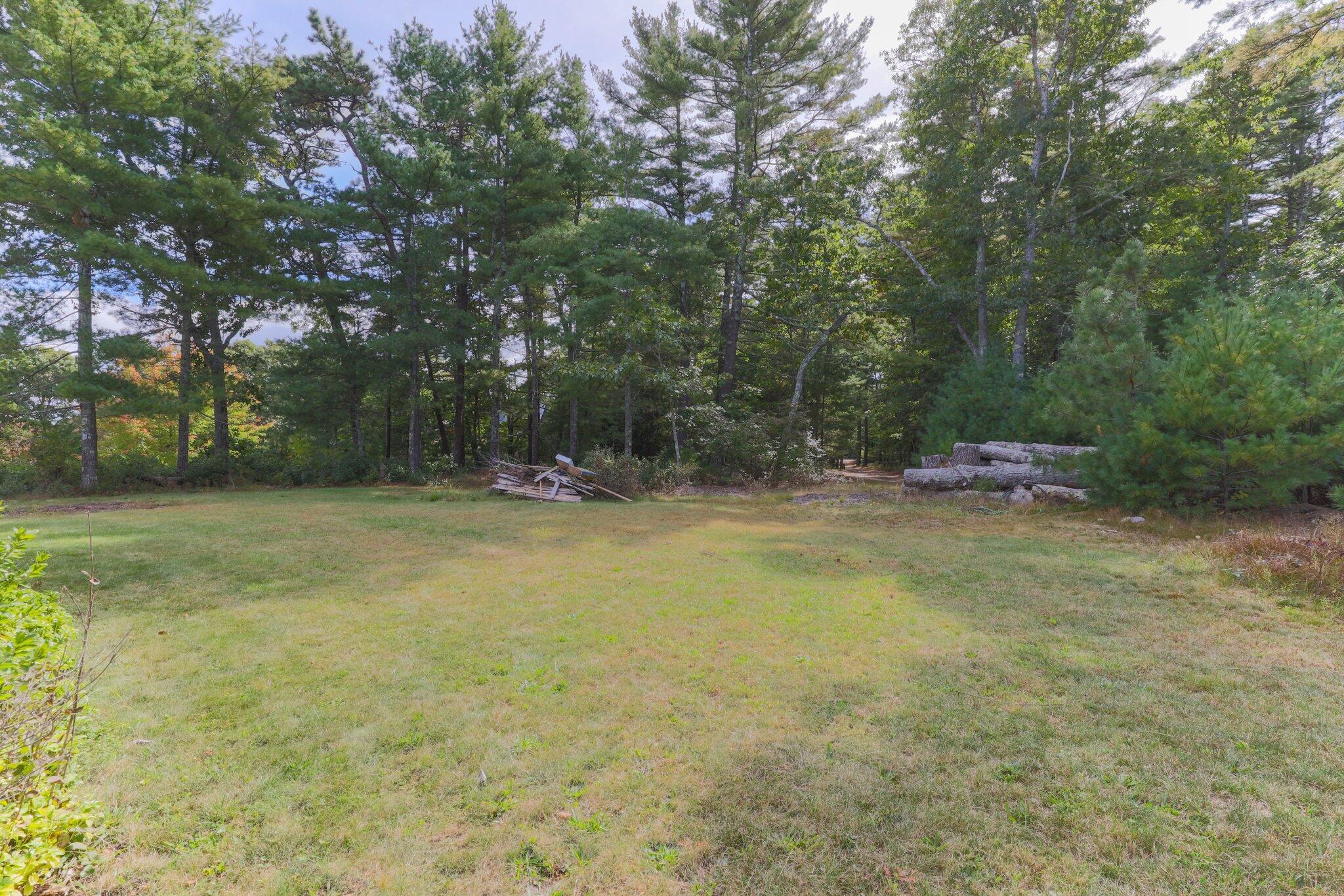 3 Fathom Lane Wareham, MA 02571 - Photo 38 of 57 a backyard of a house with fountain table and chairs