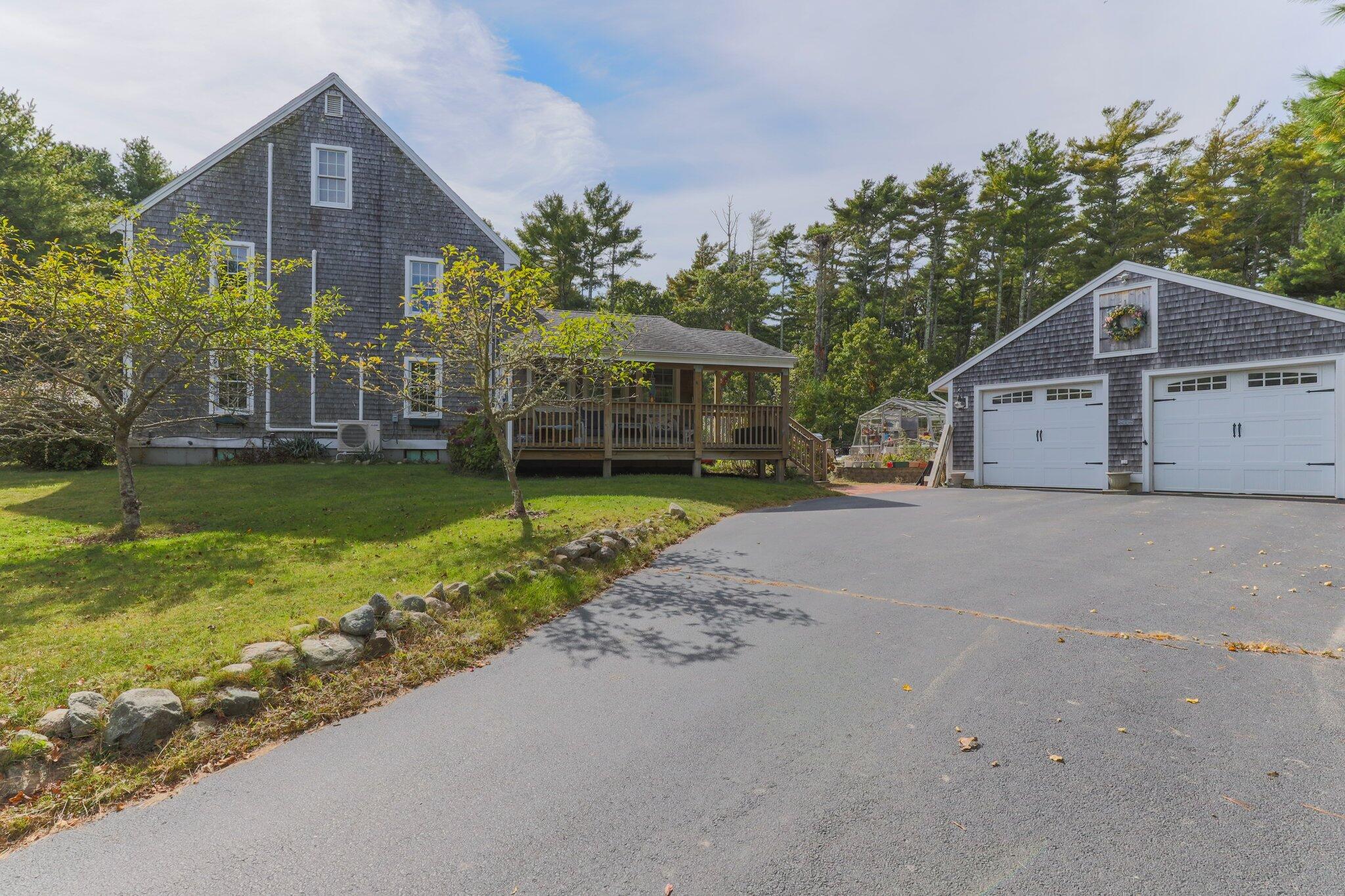 3 Fathom Lane Wareham, MA 02571 - Photo 52 of 57 a front view of a house with a yard and garage