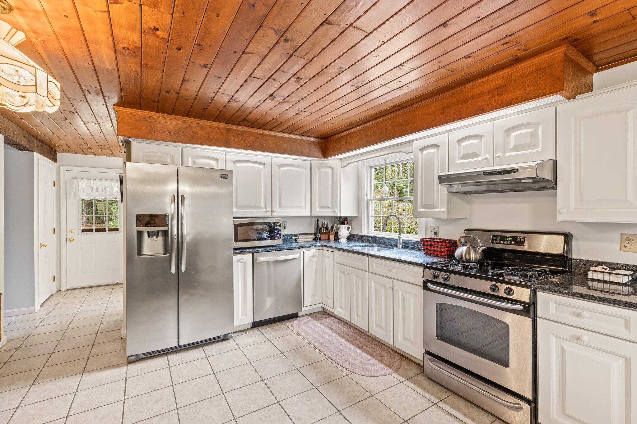 3 Fathom Lane Wareham, MA 02571 - Photo 6 of 57 a kitchen with stainless steel appliances granite countertop a stove a sink and a refrigerator