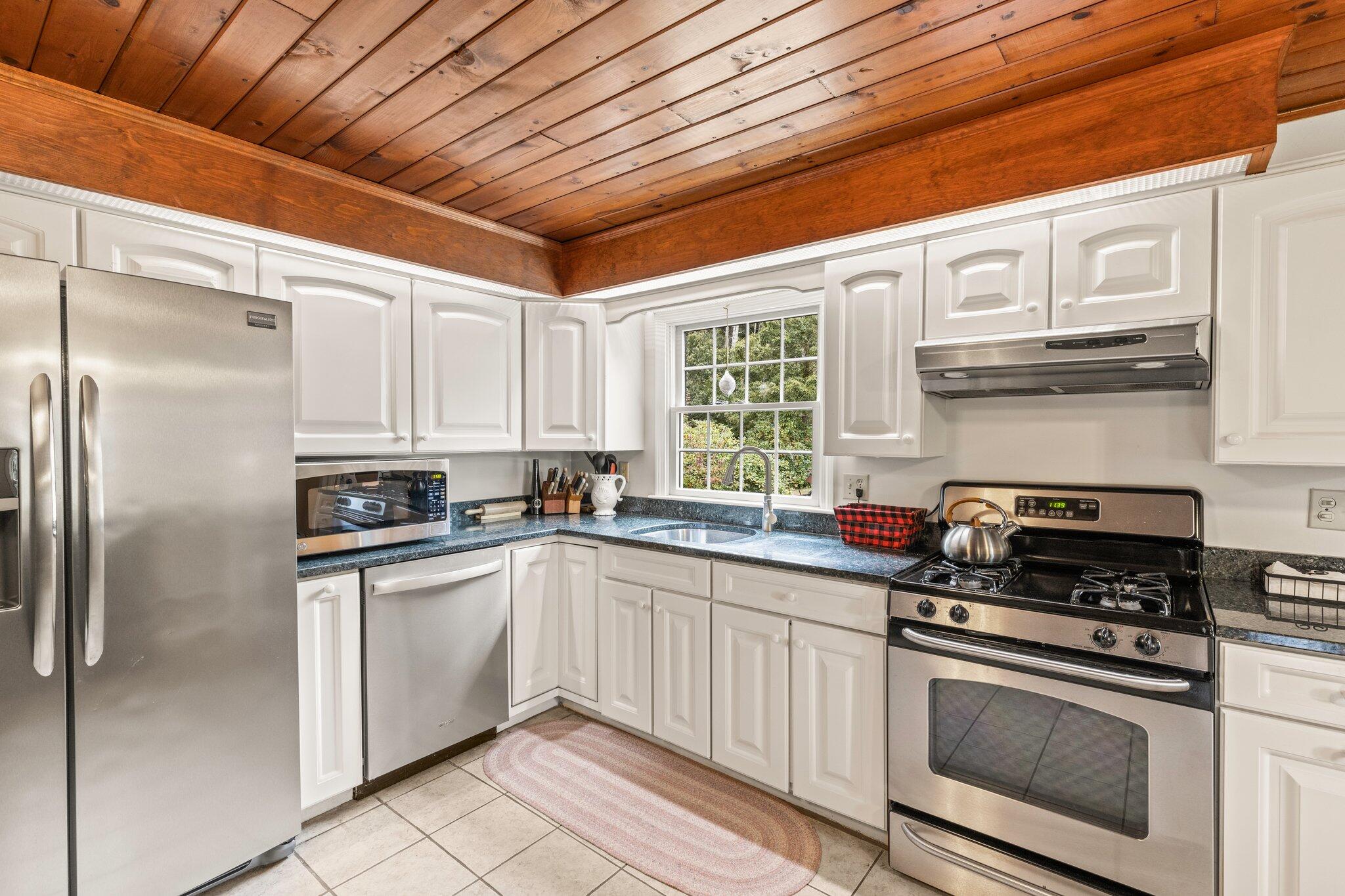 3 Fathom Lane Wareham, MA 02571 - Photo 8 of 57 a kitchen with stainless steel appliances granite countertop a refrigerator a sink dishwasher a stove and white countertops with cabinets
