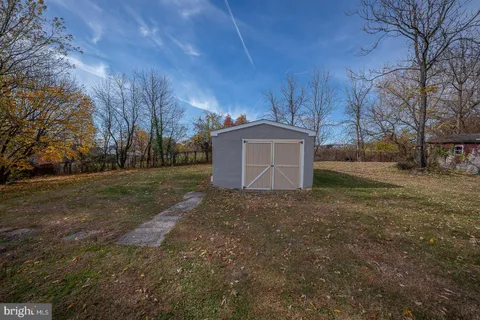 a view of a backyard with large trees
