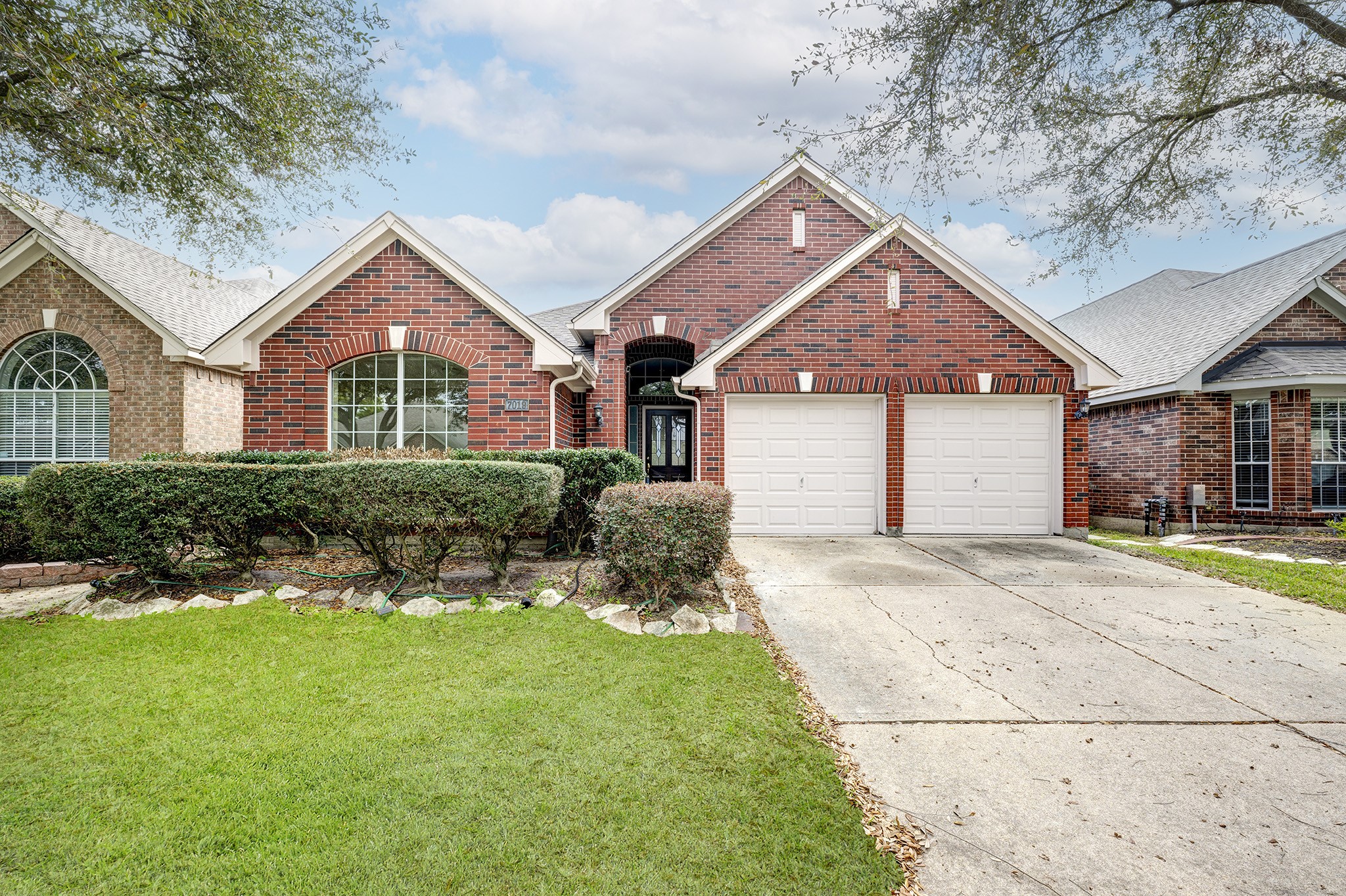 7019 Lawler Ridge Houston, TX 77055 - Photo 1 of 18 a front view of a house with a yard and garage