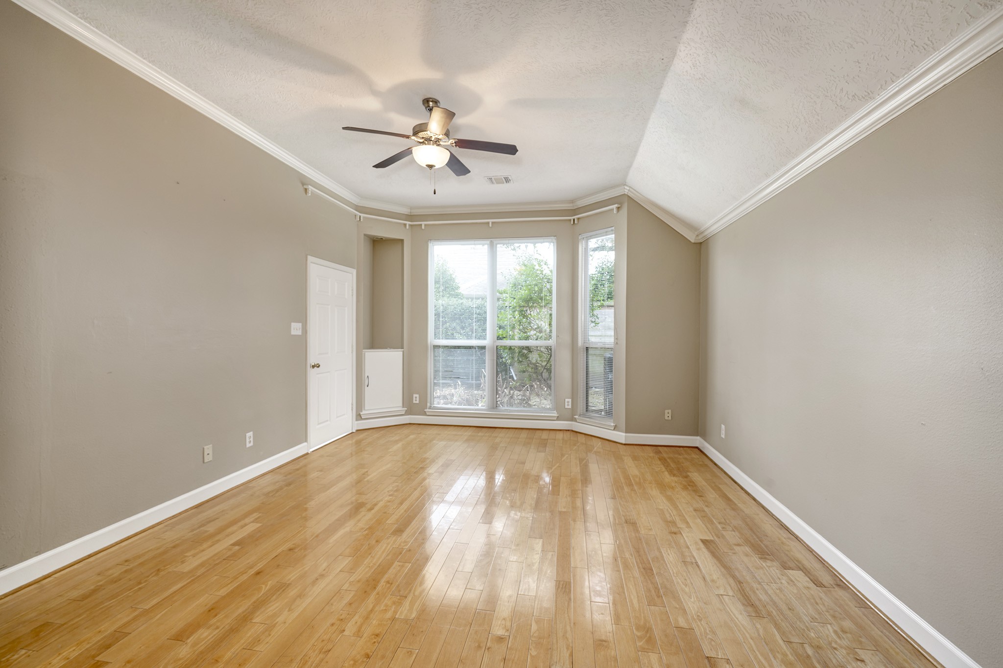 7019 Lawler Ridge Houston, TX 77055 - Photo 11 of 18 a view of an empty room with wooden floor and a window