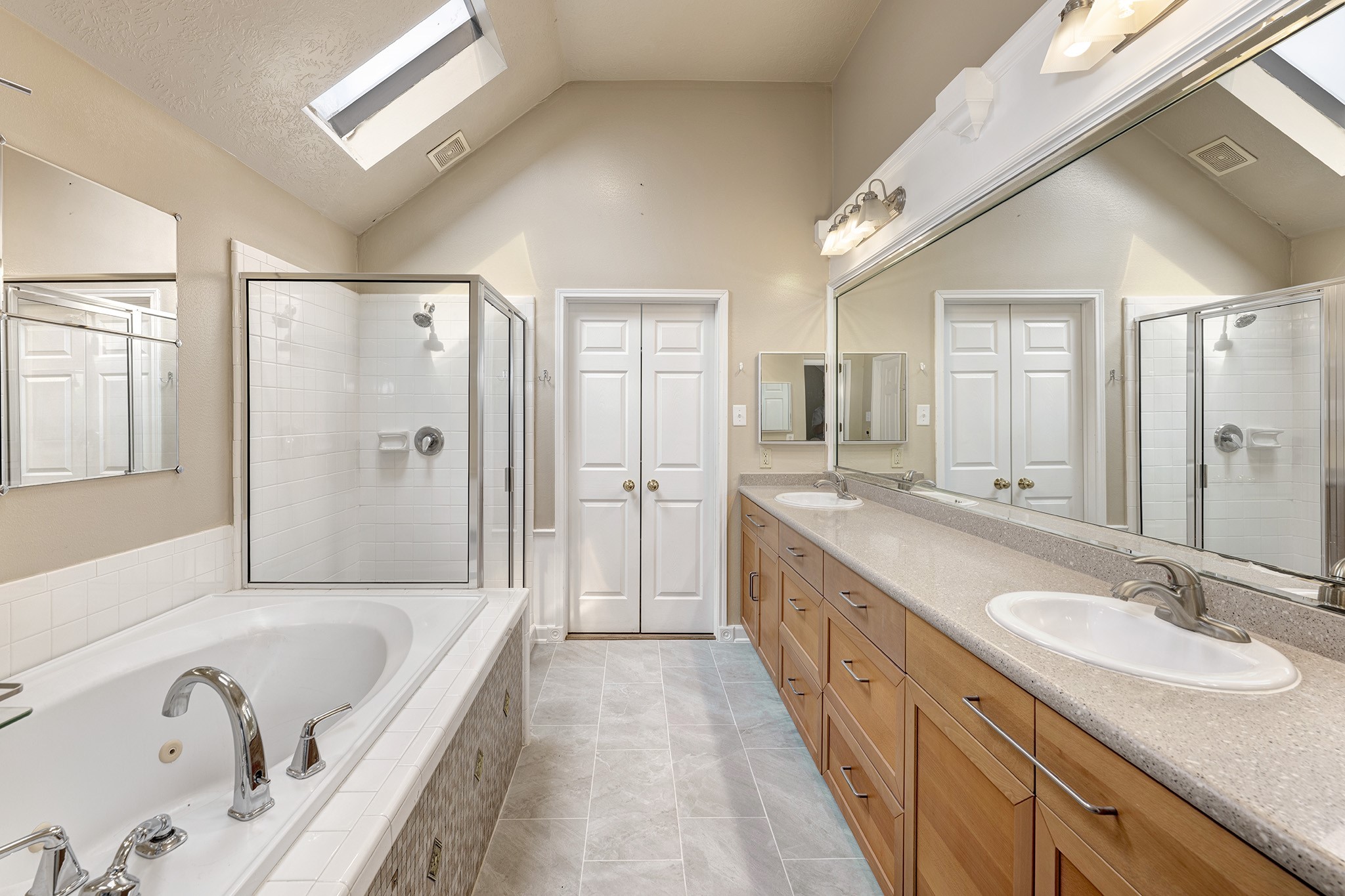 7019 Lawler Ridge Houston, TX 77055 - Photo 12 of 18 a spacious bathroom with a granite countertop tub sink shower and mirror
