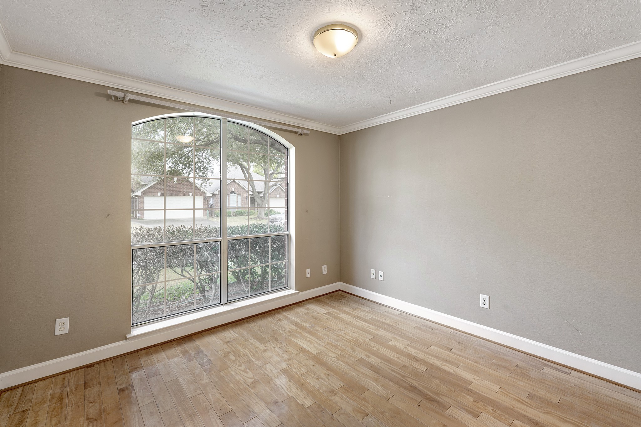 7019 Lawler Ridge Houston, TX 77055 - Photo 14 of 18 an empty room with wooden floor and windows