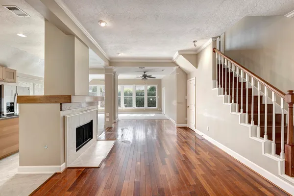 a view of a hallway with wooden floor and a fireplace