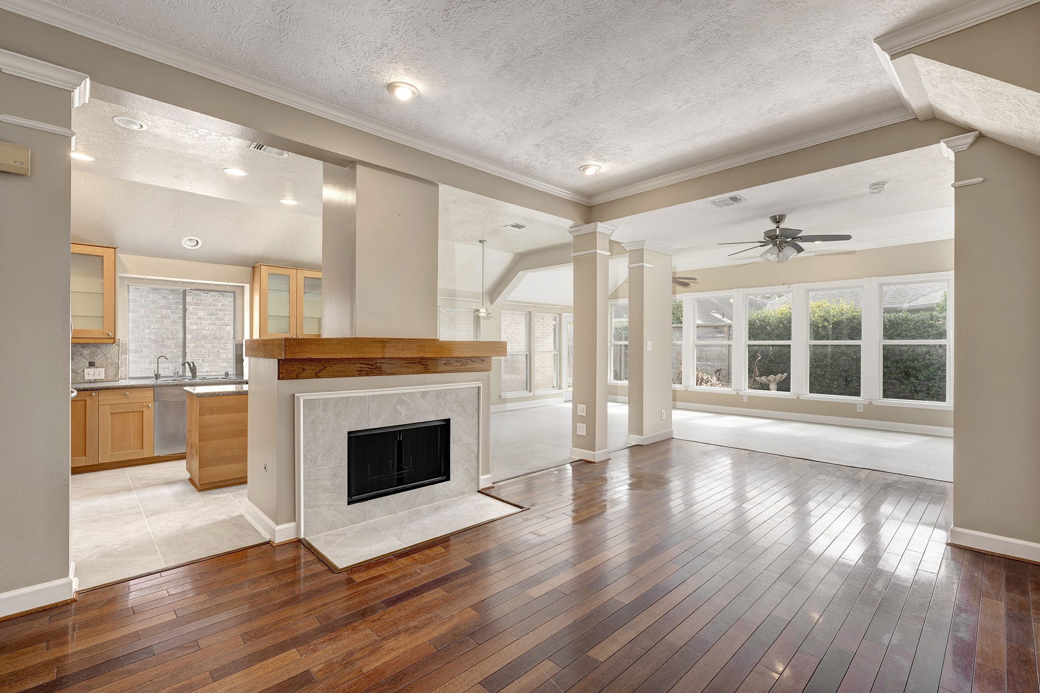 7019 Lawler Ridge Houston, TX 77055 - Photo 5 of 18 a view of an empty room with wooden floor and a kitchen