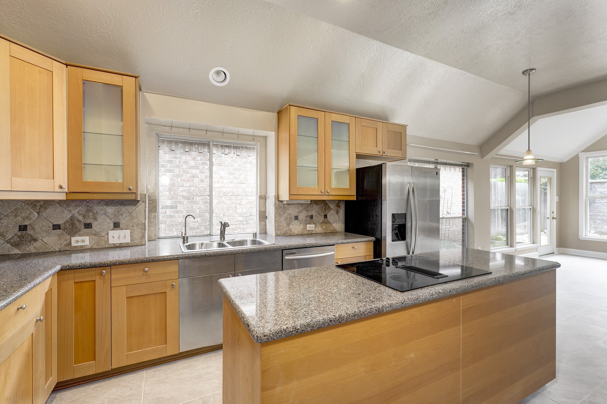 7019 Lawler Ridge Houston, TX 77055 - Photo 8 of 18 a kitchen with sink a window and cabinets
