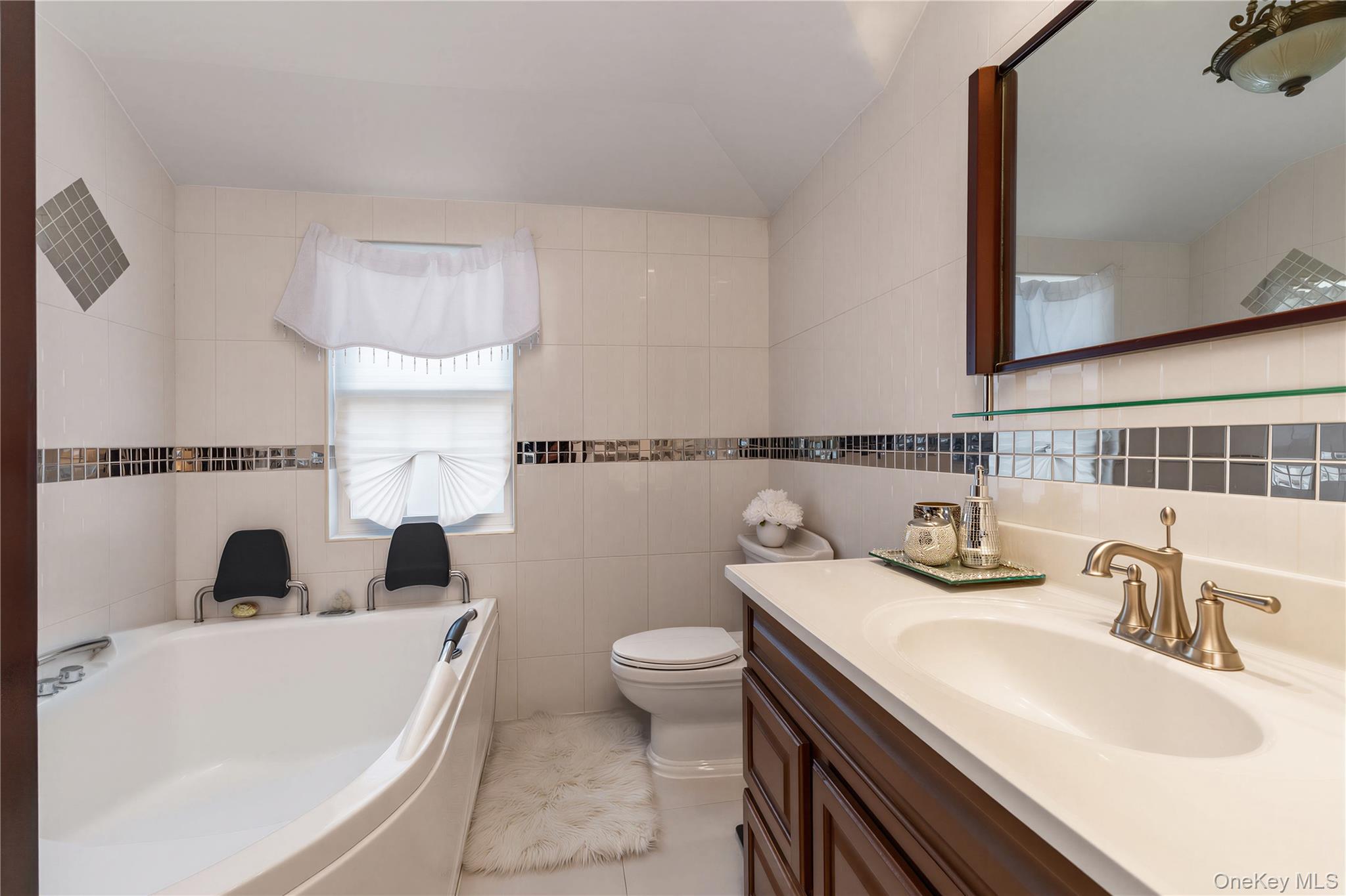 265-04 79th Avenue Queens, NY 11004 - Photo 11 of 22 a bathroom with a sink and a toilet