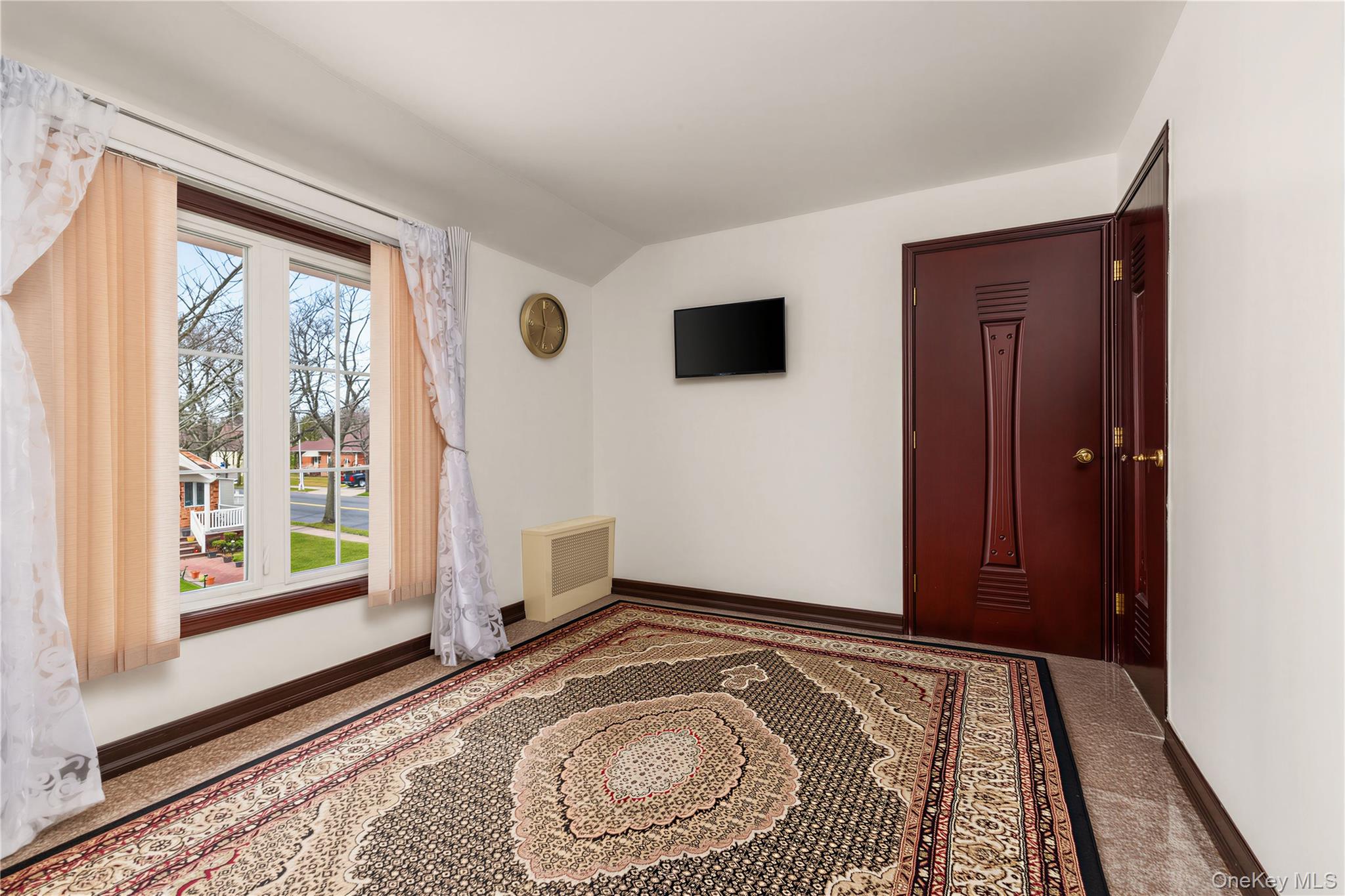 265-04 79th Avenue Queens, NY 11004 - Photo 12 of 22 a bedroom with a bed and a window