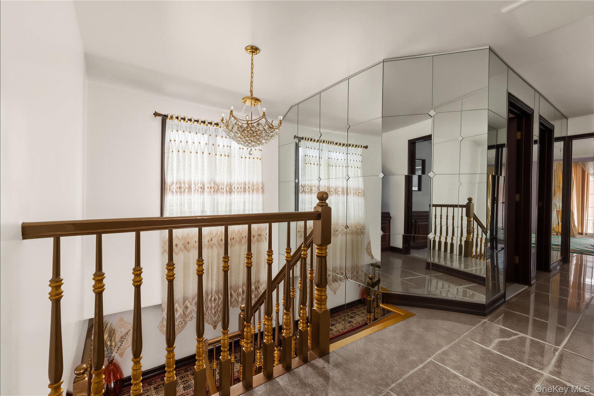 265-04 79th Avenue Queens, NY 11004 - Photo 13 of 22 a view of staircase with railing and chandelier
