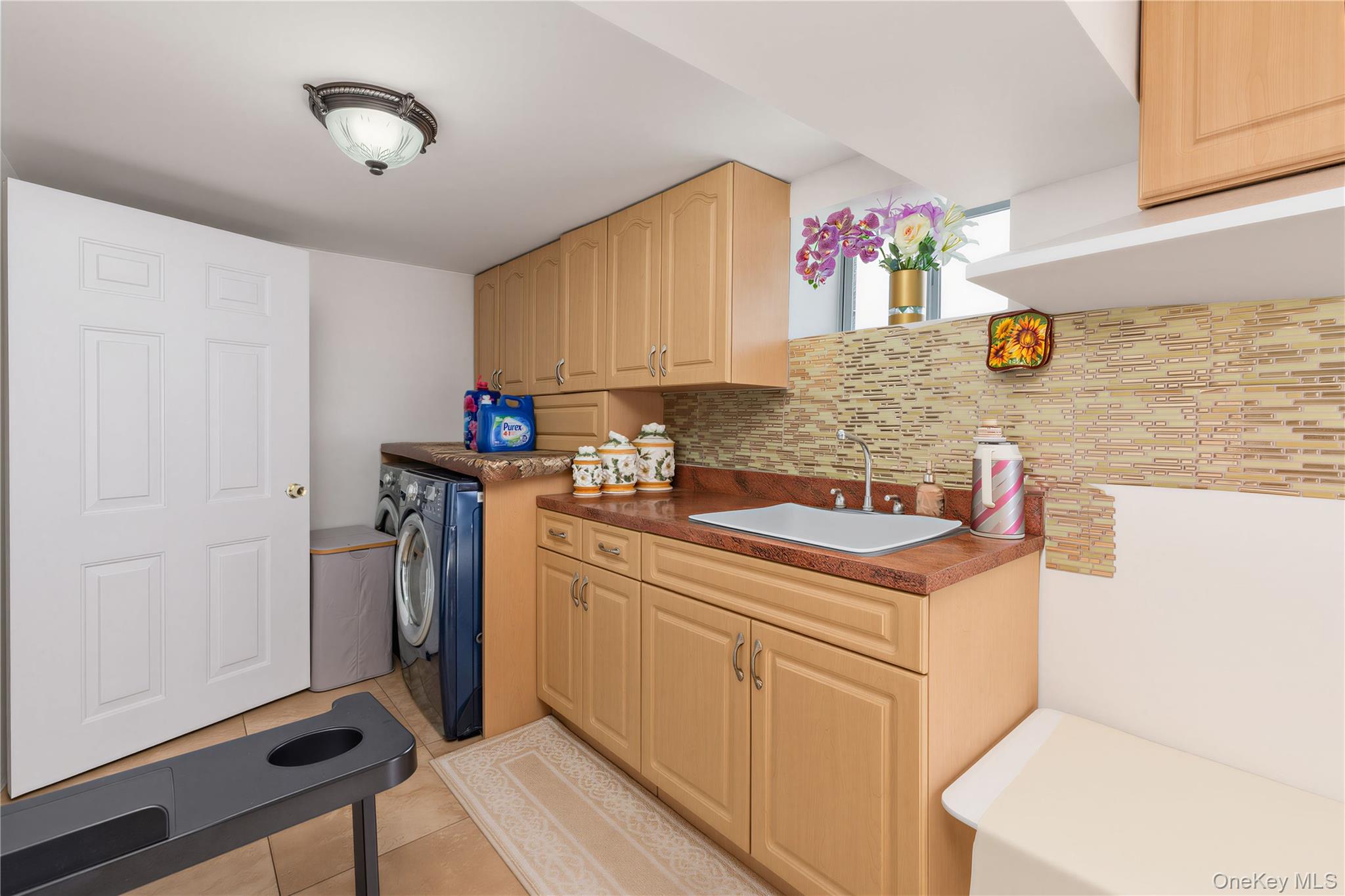 265-04 79th Avenue Queens, NY 11004 - Photo 15 of 22 a kitchen with stainless steel appliances granite countertop a sink stove and refrigerator