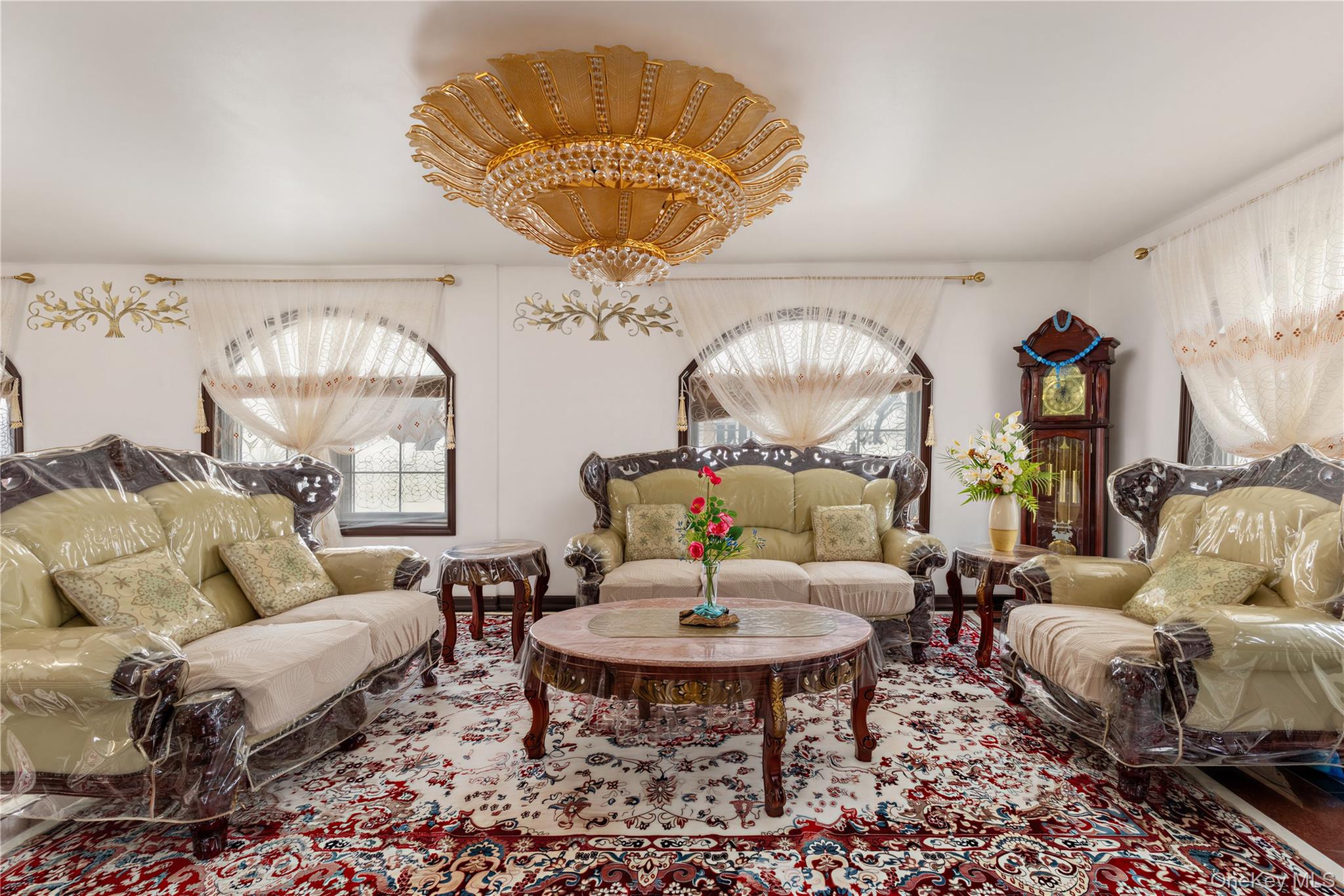 265-04 79th Avenue Queens, NY 11004 - Photo 3 of 22 a living room with furniture chandelier and a chandelier