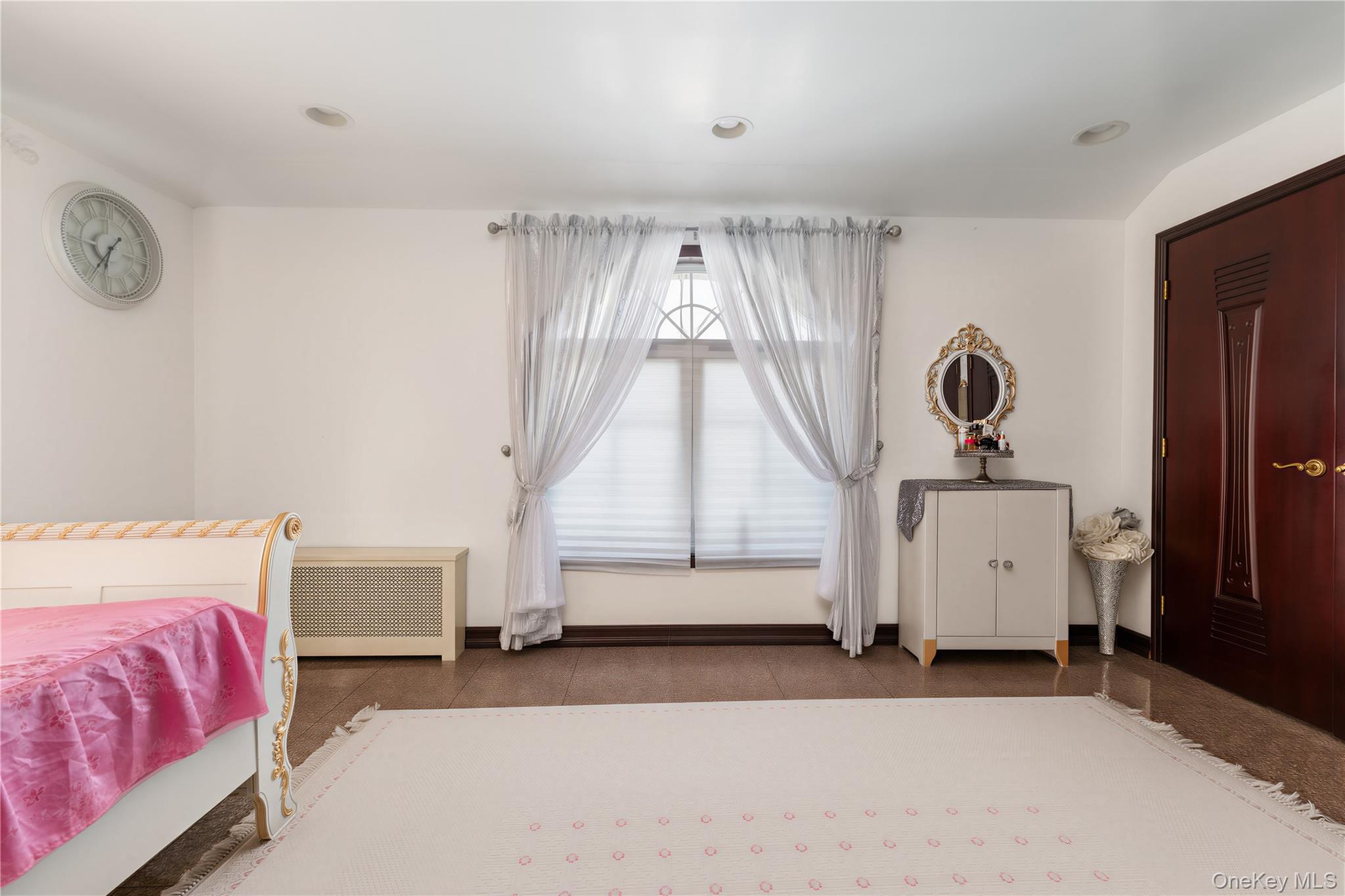 265-04 79th Avenue Queens, NY 11004 - Photo 10 of 22 a bedroom with bed and window