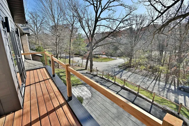 a view of balcony with wooden floor and fence