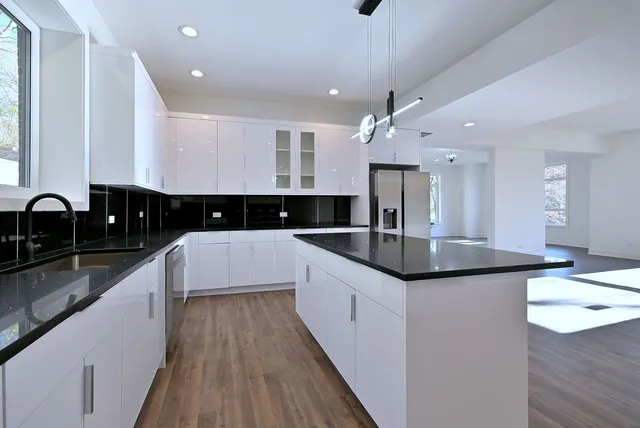 a kitchen with granite countertop counter top space a sink stainless steel appliances and cabinets
