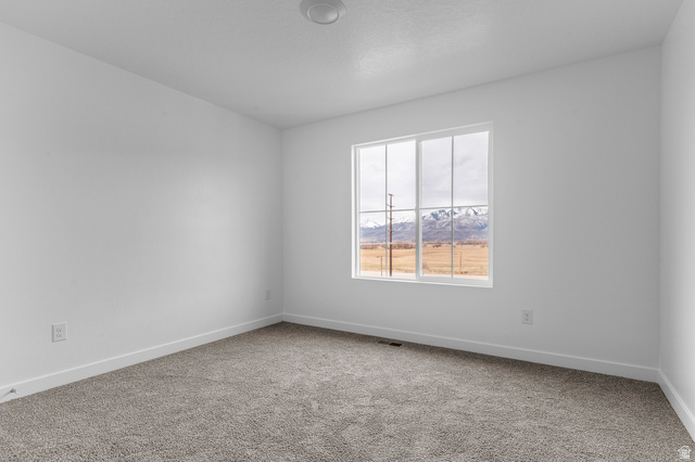 2829 South 710th West, Unit 17 Logan, UT 84321 - Photo 14 of 22 Carpeted empty room with baseboards and a mountain view