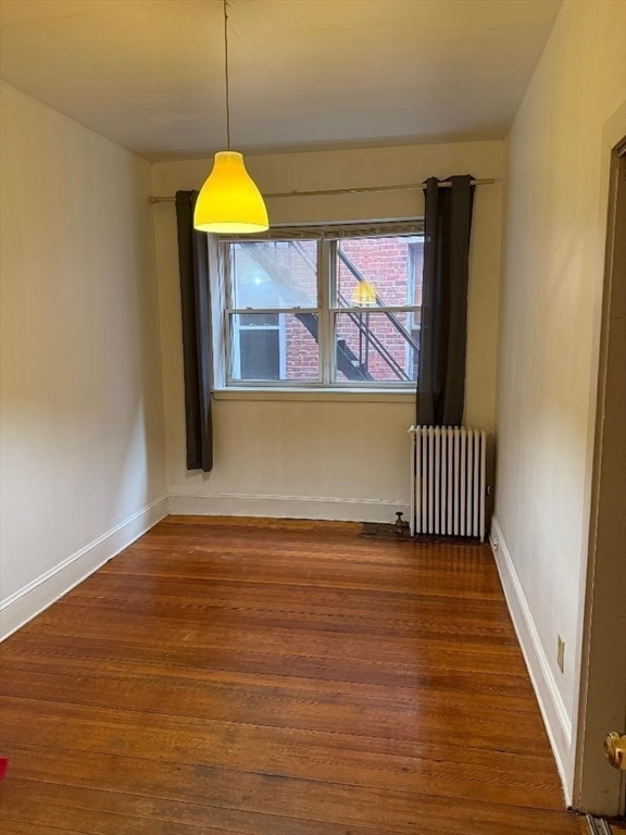 1834 Beacon Street, Unit 11 Brookline, MA 02445 - Photo 5 of 7 a view of a living room with a wooden floor