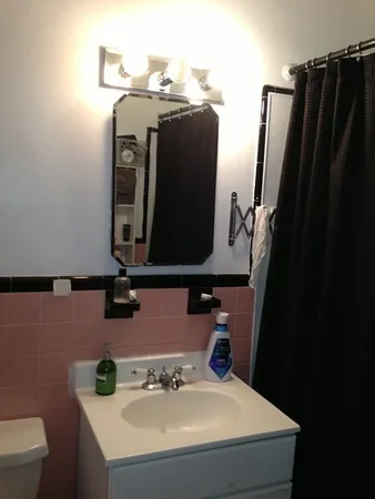 a bathroom with a sink vanity and toilet