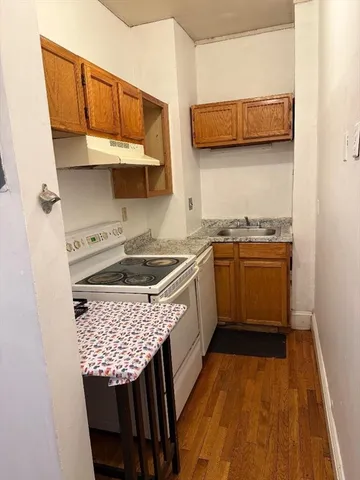 a kitchen with stainless steel appliances granite countertop a sink a stove and a microwave