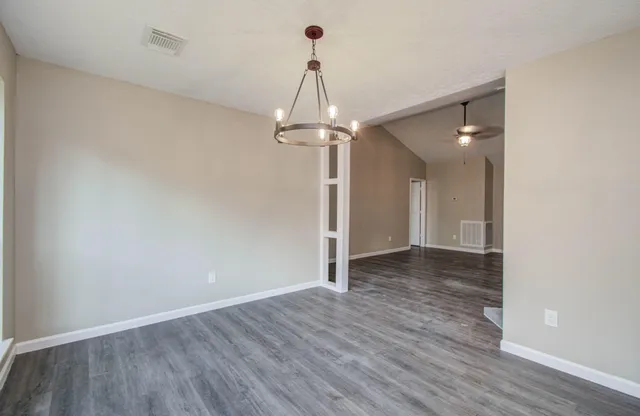 a view of a room with wooden floor