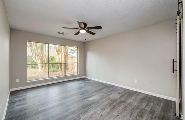a bathroom with a tub a sink and mirror