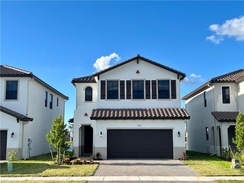 5653 Cerva Lane Ave Maria, FL 34142 - Photo 1 of 24 a front view of a house with garden
