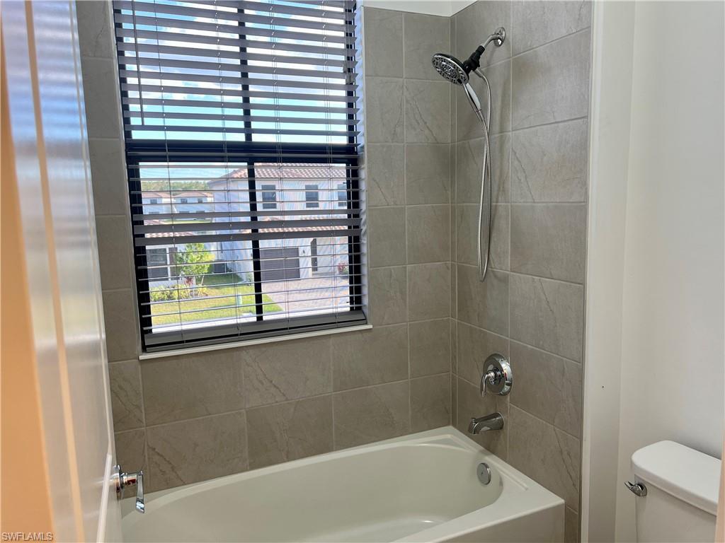 5653 Cerva Lane Ave Maria, FL 34142 - Photo 15 of 24 a bathroom with a bathtub and a shower