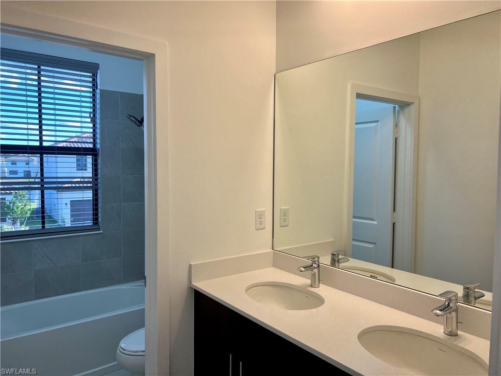 5653 Cerva Lane Ave Maria, FL 34142 - Photo 16 of 24 a bathroom with a granite countertop sink toilet and shower