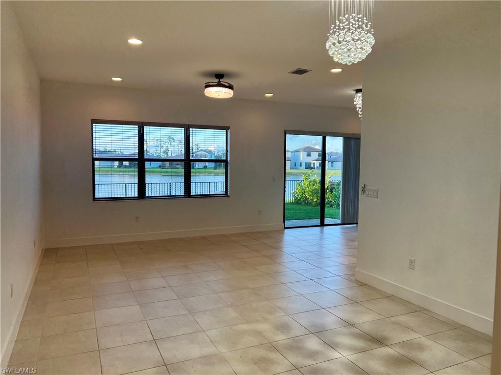 5653 Cerva Lane Ave Maria, FL 34142 - Photo 2 of 24 an empty room with wooden floor and windows
