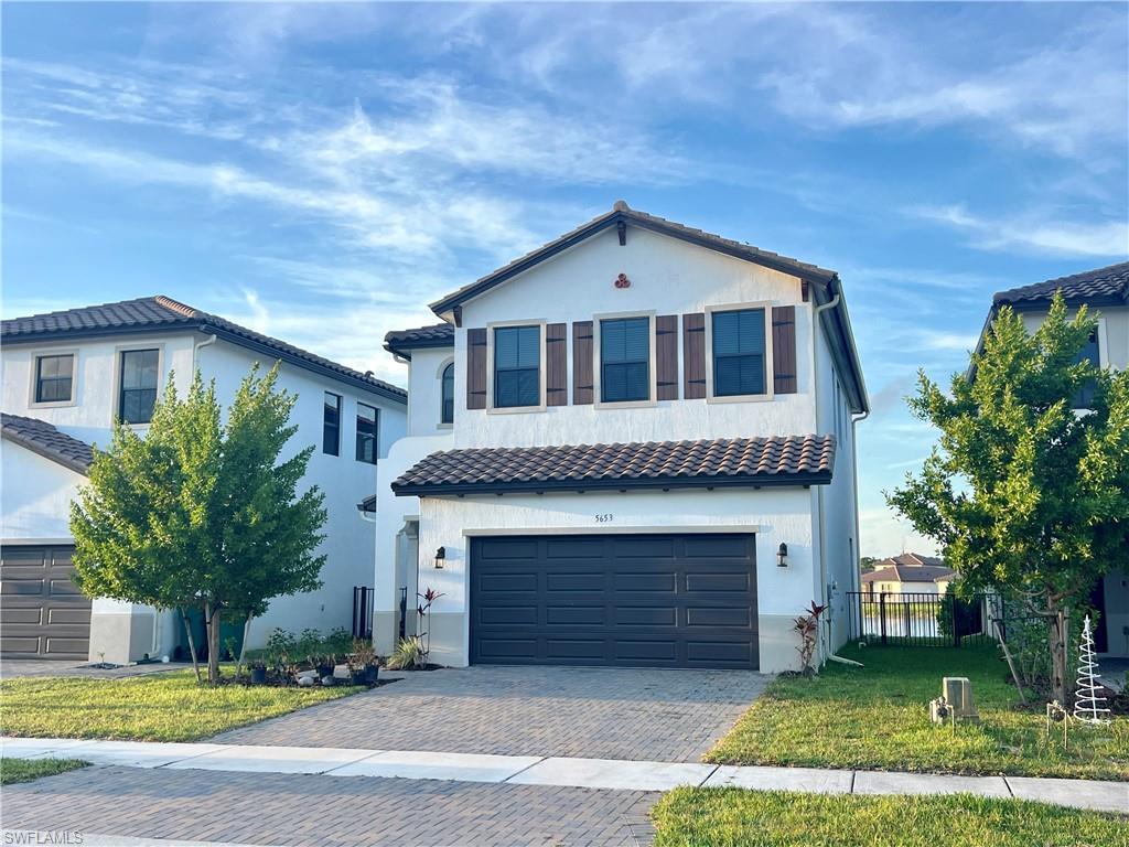 5653 Cerva Lane Ave Maria, FL 34142 - Photo 21 of 24 a front view of a house with a yard and garage