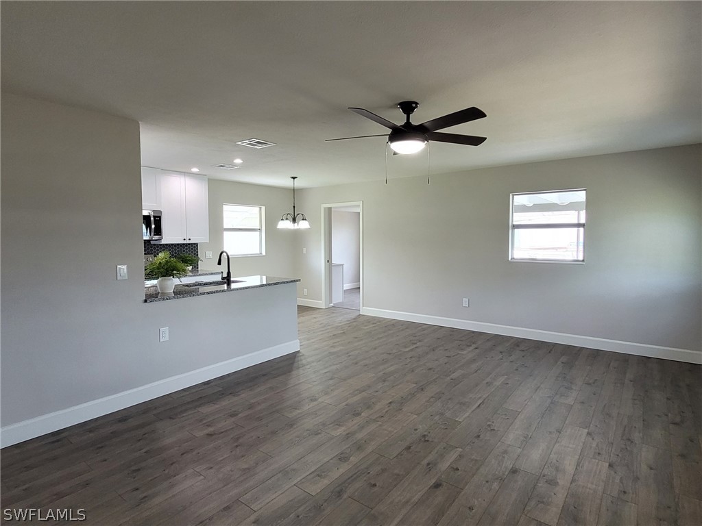 105 Alabama Road South Lehigh Acres, FL 33936 - Photo 10 of 25 a view of a kitchen with a dishwasher and a window