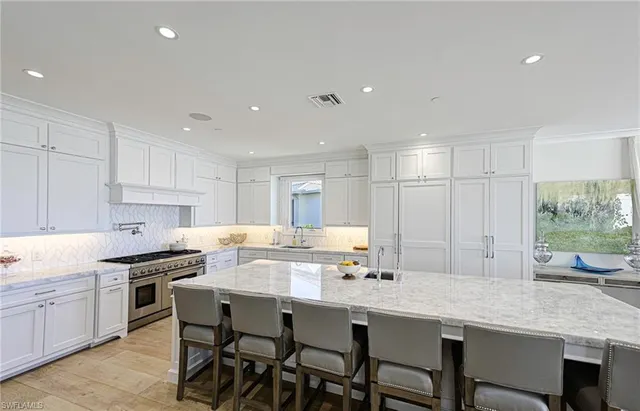 a kitchen with a table chairs sink and cabinets