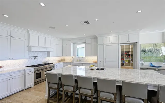 a kitchen with appliances a sink and cabinets
