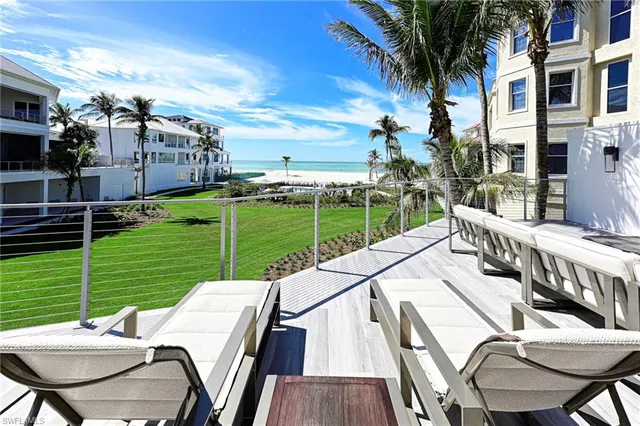 a view of a patio with a table chairs and a backyard