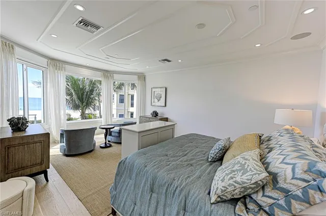 a spacious bedroom with a large bed and windows