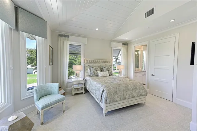 a spacious bedroom with a bed and a couch