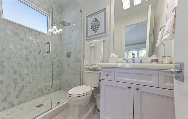 a bathroom with a sink a toilet and a shower