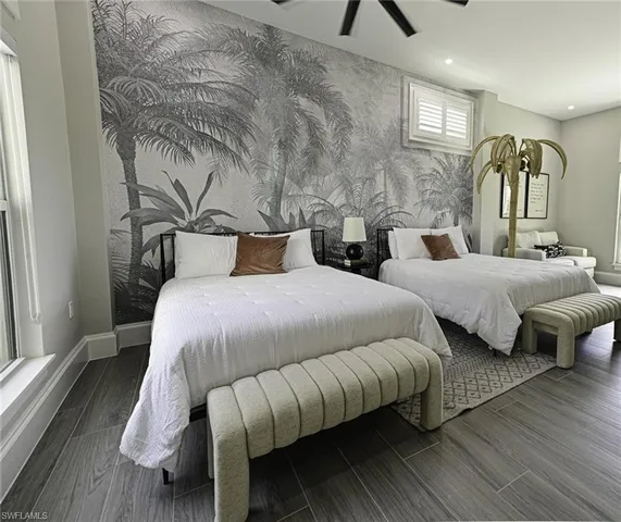 a bedroom with bed and wooden floor