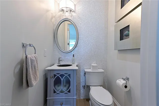 a bathroom with a toilet a sink and a mirror